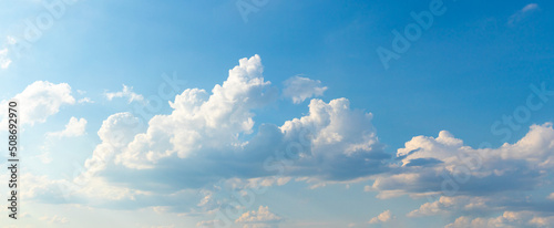 Canvas Print White curly clouds in the blue sky in sunny weather