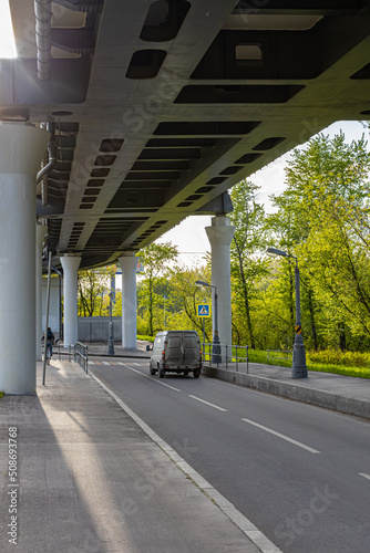 an empty road passing under an elevated overpass © Oleg Opryshko