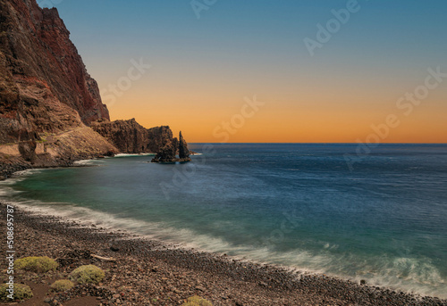 Las Almorranas beach with sunset light, Roque de Bonanza volcanic rock formation, long exposure photography, Valverde, El Hierro, Canary islands, Spain photo