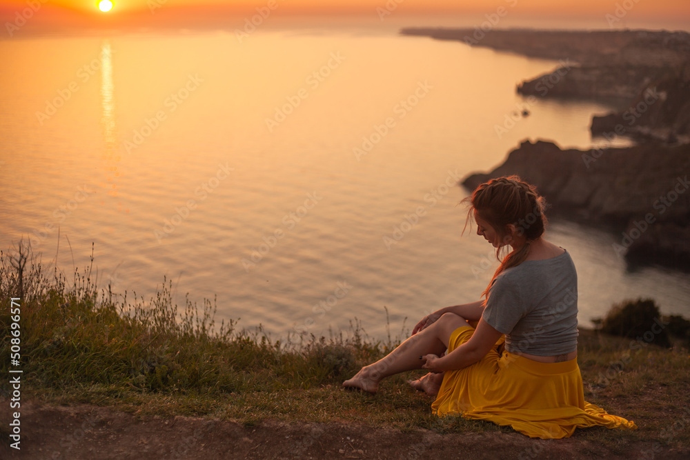 Young woman engaged in yoga in nature with view and warm light of sunset, makes poses enjoy the meditation, balance and sunrise