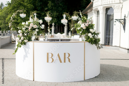 Bar counter decorated with flowers at a wedding party