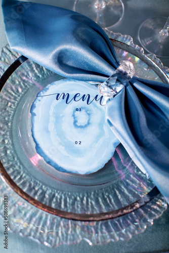 Cards with inscriptions on a plate on a wedding table