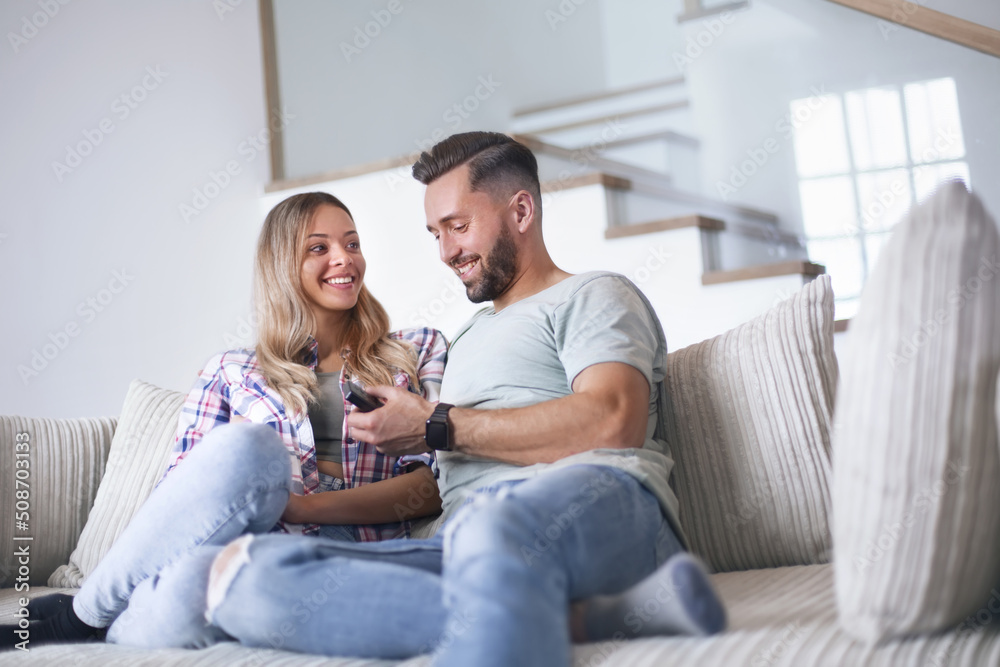loving couple sitting on sofa in cozy living room loving couple sitting on sofa in cozy living room