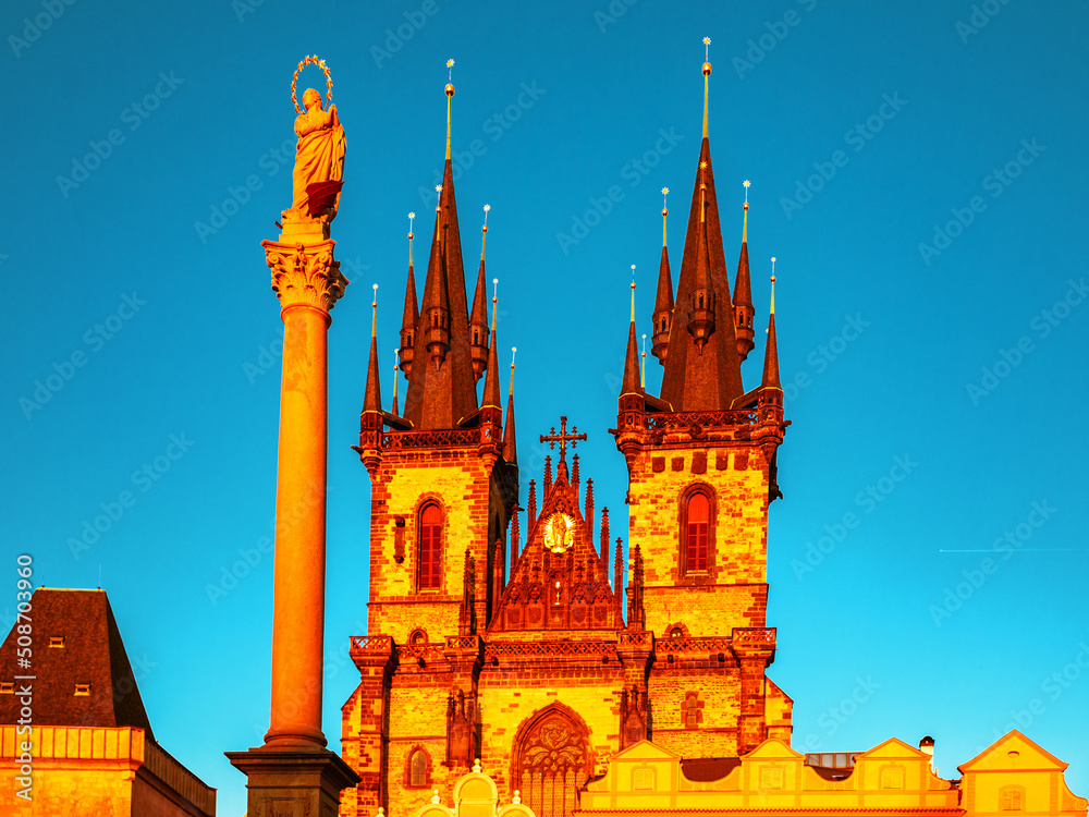 Marian column and Church of Our Lady before Tyn on Old Town Square in Prague, Czech Republic, on blue sky background