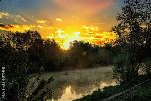 A beautiful sunrise over the river in the early morning. © Marina