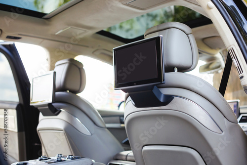 Entertainment system for rear passengers in a car with two monitors. © kucheruk