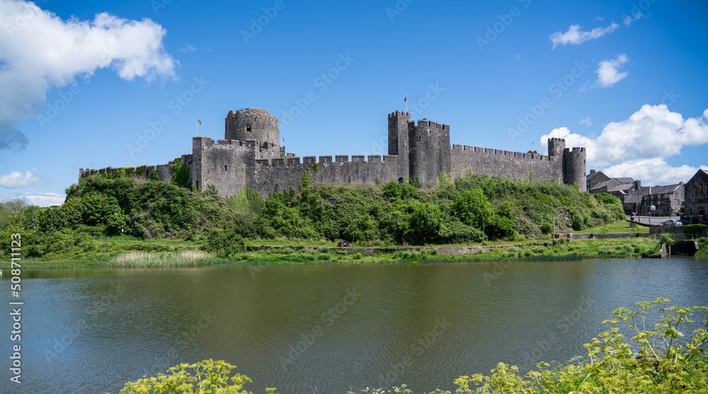 view of the stunning Pembroke Castle over Pembroke river, blue sky background view of the stunning Pembroke Castle over Pembroke river, blue sky background
