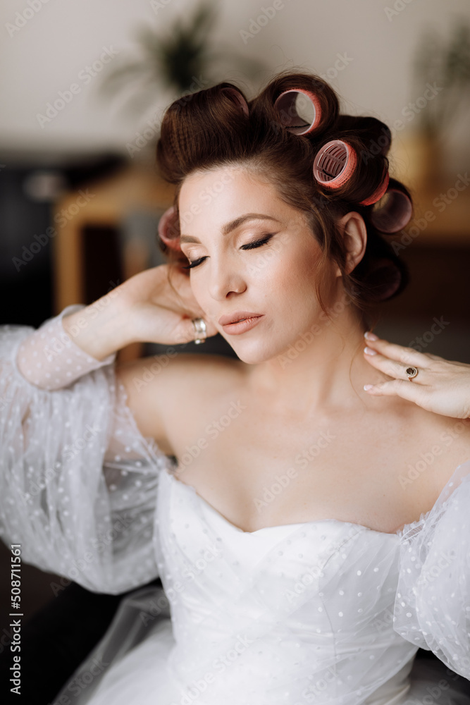 beauty concept. portrait of a beautiful young showy brunette woman with bright pin-up make-up in pink curlers. Studio Shot, Cropped. Facial treatment . Cosmetology , skin care and spa beauty concept. portrait of a beautiful young showy brunette woman with bright pin-up make-up in pink curlers. Studio Shot, Cropped. Facial treatment . Cosmetology , skin care and spa