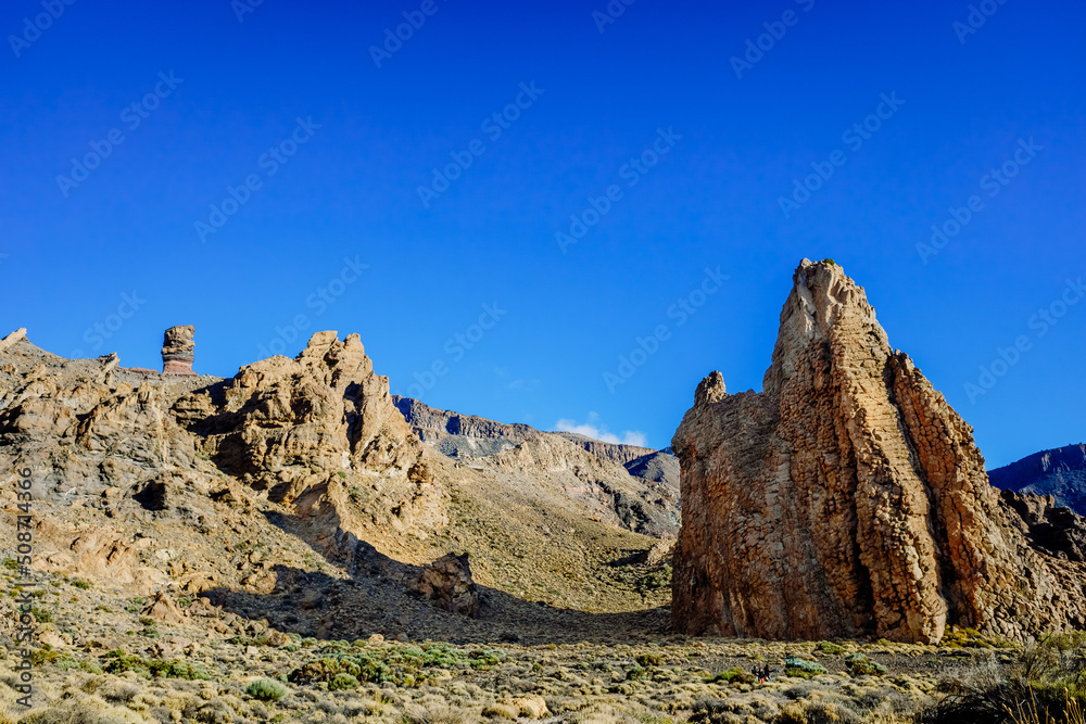 vertical rock stone formations on a bright sky sunny day