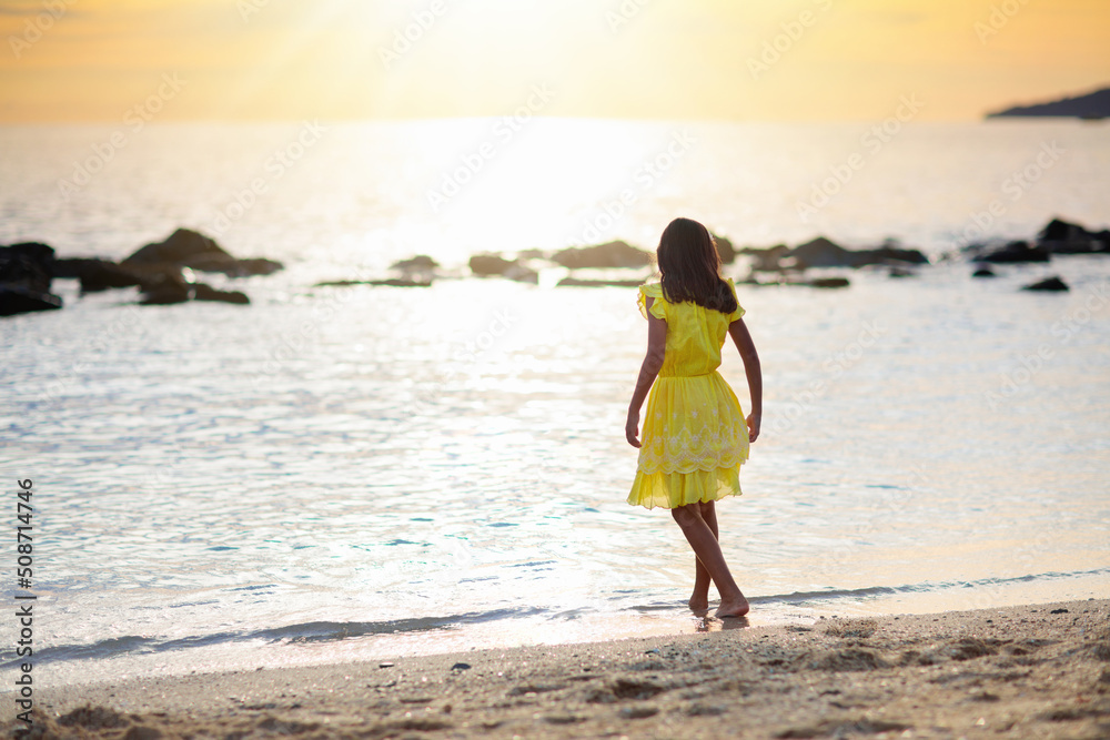 Little girl playing on tropical beach