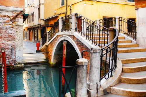 Clorful buildings with a pedestrian bridge. Canal in Venice, Italy © tsezarina