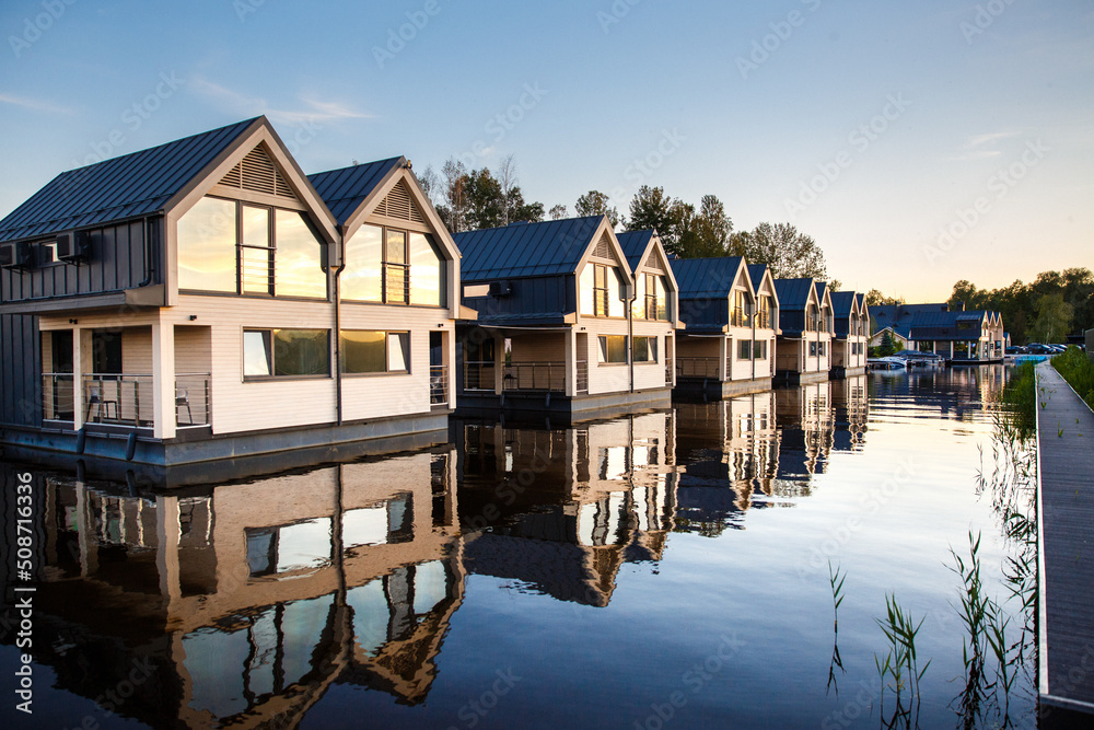 Row of houses with mirror windows on the lake Row of houses with mirror windows on the lake