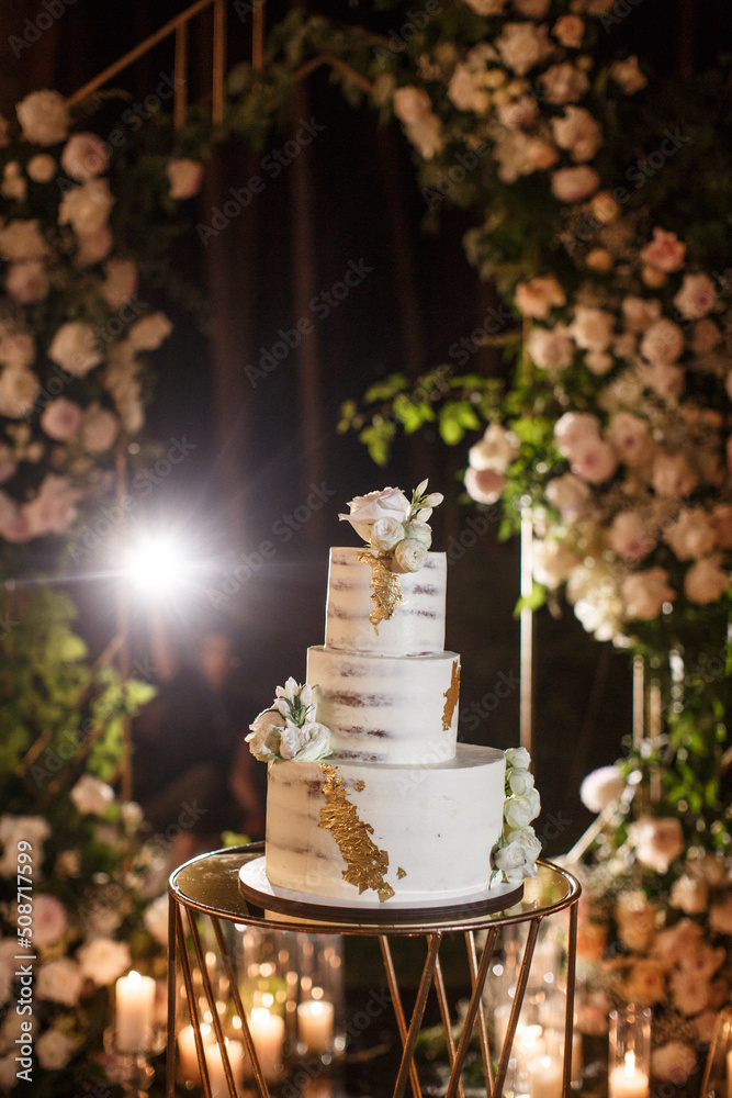 Wedding cake in the ceremony area decorated with flowers