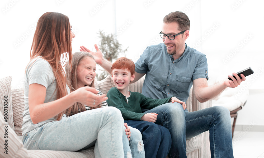 cheerful family sitting on the couch in the living room