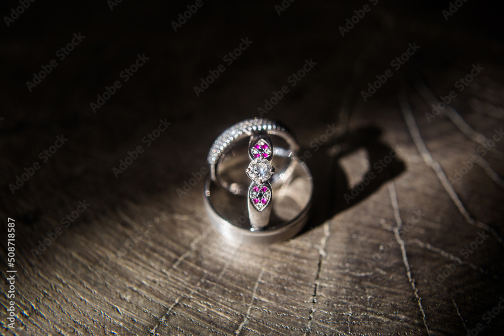Three wedding ring on a wooden background Three wedding ring on a wooden background