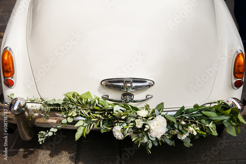 Vintage wedding car decorated with flowers, close up photo