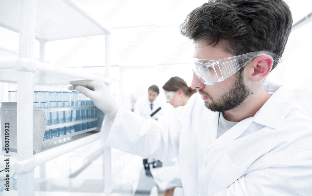 side view of focused scientist holding test tube in laboratory side view of focused scientist holding test tube in laboratory