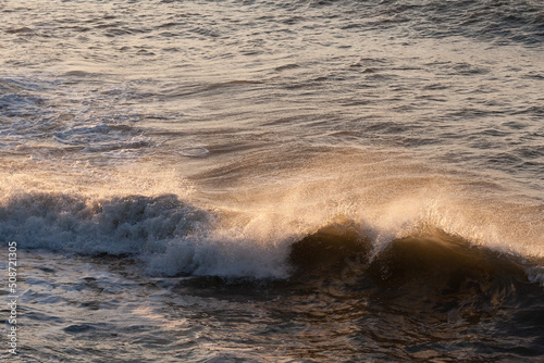 waves highlighted by golden sunlight during golden hour.
