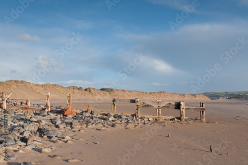 Old wooden groynes at crow point beach, Devon, UK