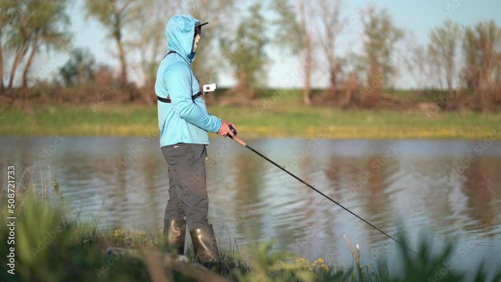 The fisherman sportsman catches a predatory fish on a spinning on the lake The fisherman sportsman catches a predatory fish on a spinning on the lake