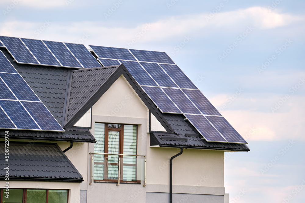 Private home roof covered with solar photovoltaic panels for generating of clean ecological electric energy in suburban rural town area. Concept of autonomous house Private home roof covered with solar photovoltaic panels for generating of clean ecological electric energy in suburban rural town area. Concept of autonomous house