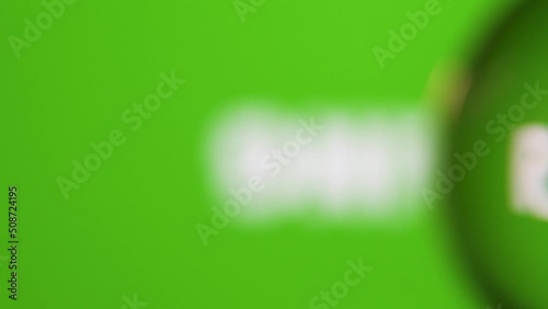 Passing in front of a glass ball with dolly and we read message about nature on the screen behind against green background. 4K native resolution.