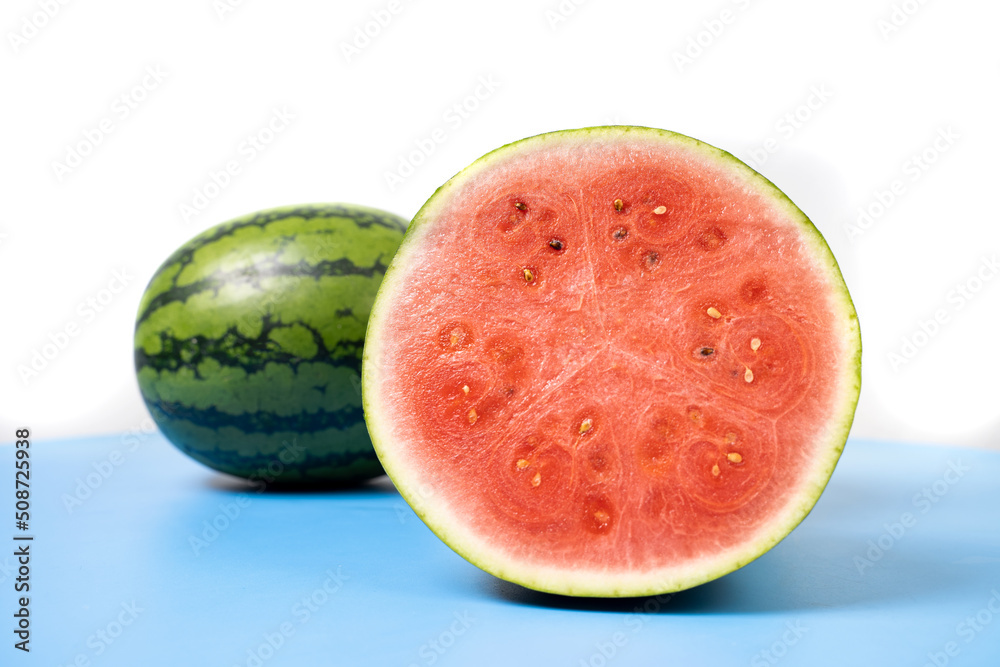 Fresh watermelon cut in half.
Watermelons with green skin colour and red flesh inside on a white background. Fresh watermelon cut in half.
Watermelons with green skin colour and red flesh inside on a white background.