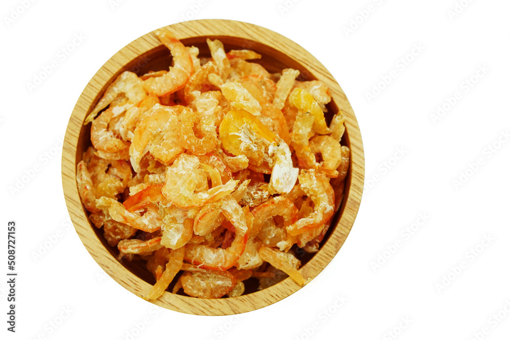 Pile of dried shrimp in wooden plate isolated on white background Pile of dried shrimp in wooden plate isolated on white background