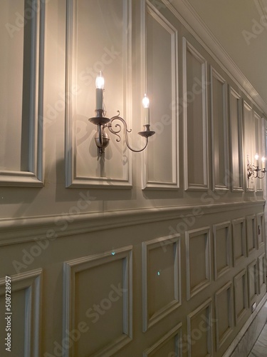 Interior wall panels with candle shape lights, dim light year 2022 summer Tokyo Japan city
