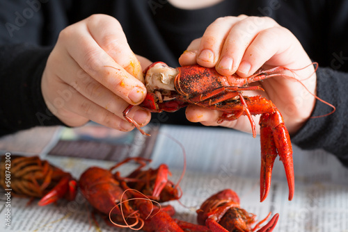 Person Peeling a Boiled Crawfish