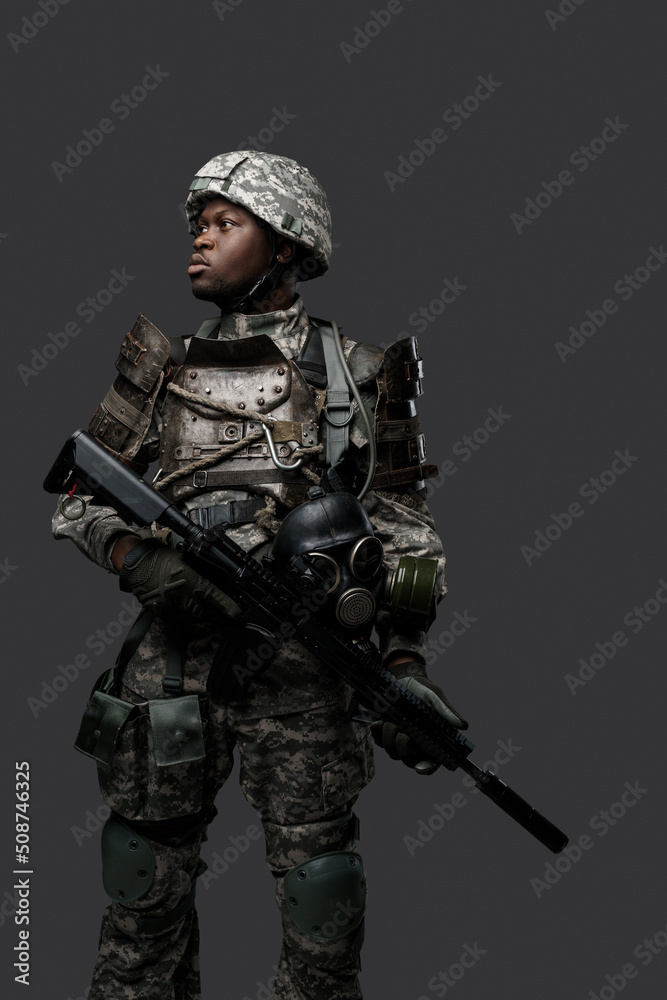 Portrait of african military man dressed in modern camouflage uniform holding rifle. Portrait of african military man dressed in modern camouflage uniform holding rifle.