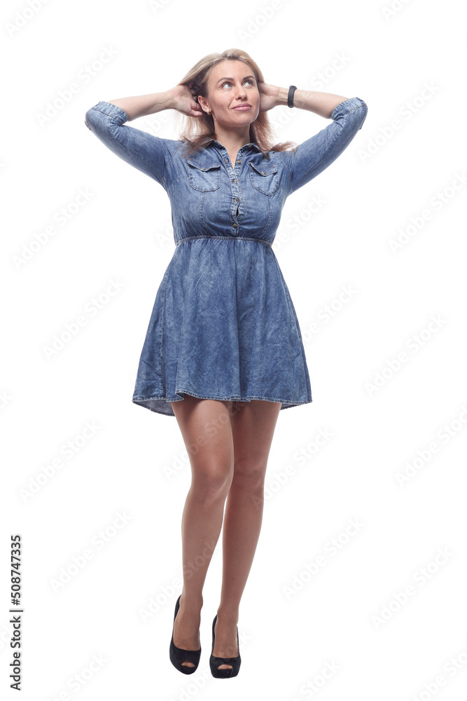 thoughtful young woman in a denim dress looking at a white screen. thoughtful young woman in a denim dress looking at a white screen.