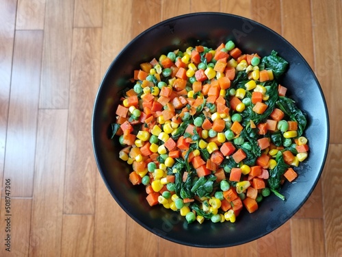 Peas, carrots, corn and spinach vegetarian dish