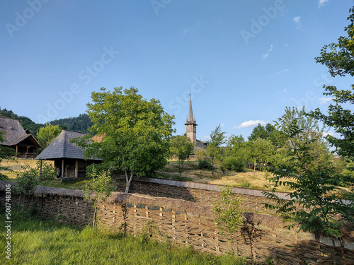 the wooden orthodox church and other wooden houses at the Village Museum in Baia Mare city, Maramures, Romania