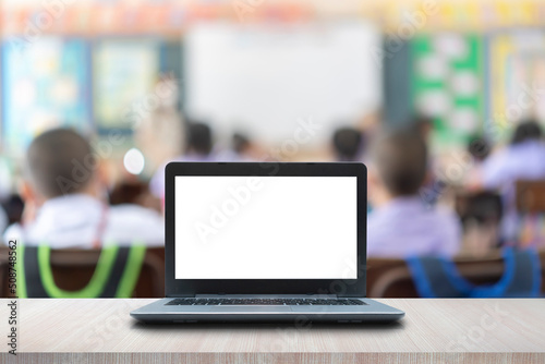 Modern laptop with blank screen on table in classroom