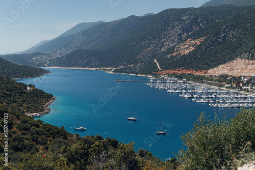 Beautiful view of the bay with ships and mountains. Sea bay with luxury yachts on the coast of Turkey. Colorful, summer landscape. Travel concept. Aegean Sea. Journey. Sea Voyage