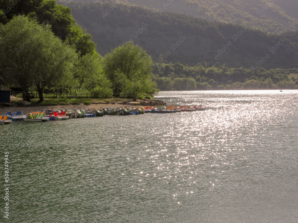 Obraz premium Image of Lake Scanno with pedal boats in the background. Travel to Abruzzo Italy