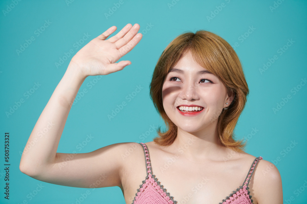 Beautiful woman face isolated on turquoise background, concept for skin care and sun block UV care, asian beauty Beautiful woman face isolated on turquoise background, concept for skin care and sun block UV care, asian beauty