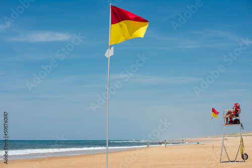Fototapeta yellow and red flag delimiting the supervised bathing area