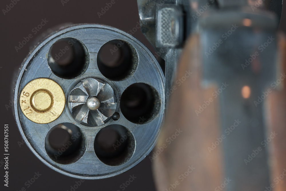Russian roulette. The drum of a revolver in which only is a cartridge.  Stock Photo | Adobe Stock