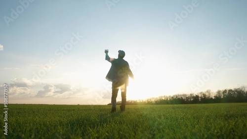 agriculture. man farmer a agronomist walk green field of wheat grass. agriculture farming sunset business concept. male farmer silhouette at walk. agriculture healthy food business farming concept