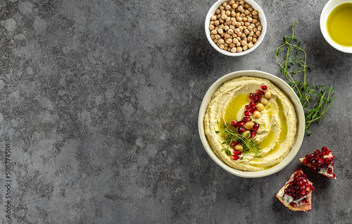 Healthy homemade hummus, made with tahini, lime, olive oil, and chickpeas. Perfect for dipping and can be used in sandwiches, salads, and burgers. Flat lay, copy space for the recipe.