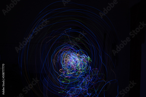 Light painting Abstract colorful irregular lines or patterns on black background with long exposure.