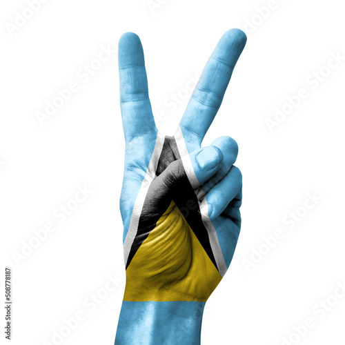 Hand making the V victory sign with flag of saint lucia