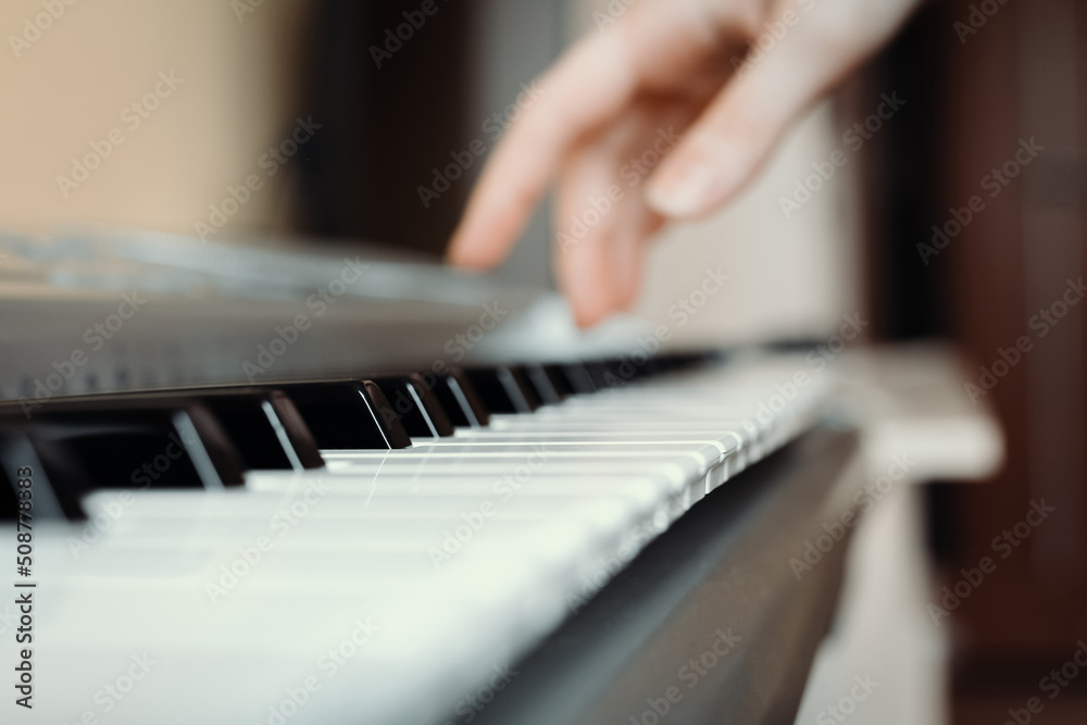 Synthesizer keys with selective focus and hand in the background, synth playing Synthesizer keys with selective focus and hand in the background, synth playing