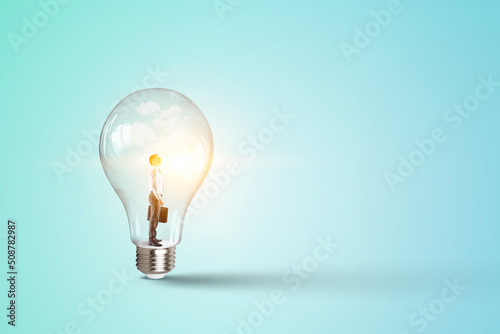 Businessman inside shiny light bulb