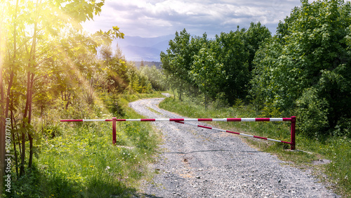 Iron barrier on a forest road. No entry into the forest.