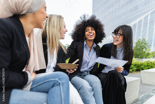 Canvas Print Multiracial business women taking a break eating a meal outside the office