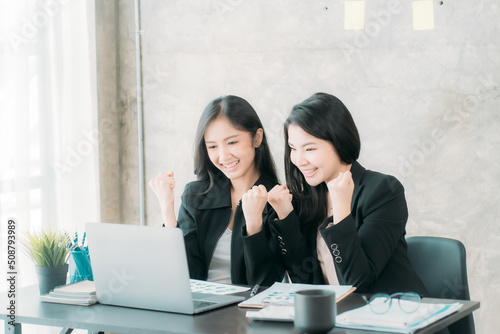 Asian woman sitting at a desk working in the office use a computer, laptop