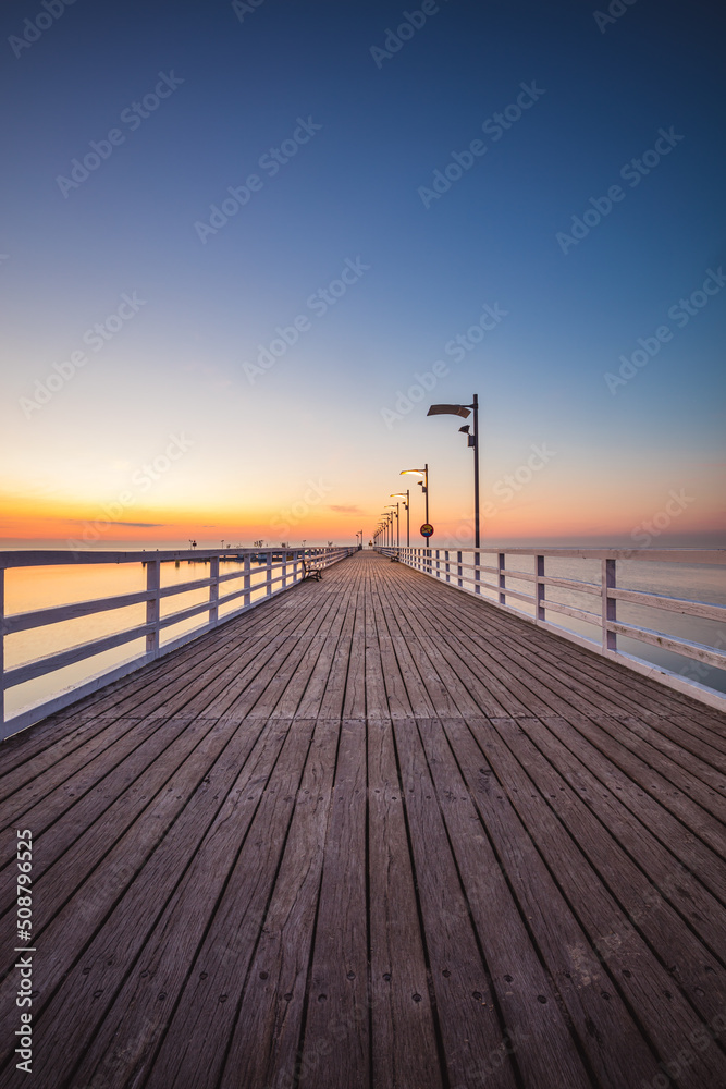 Sunrise over the pier in Mechelinki.